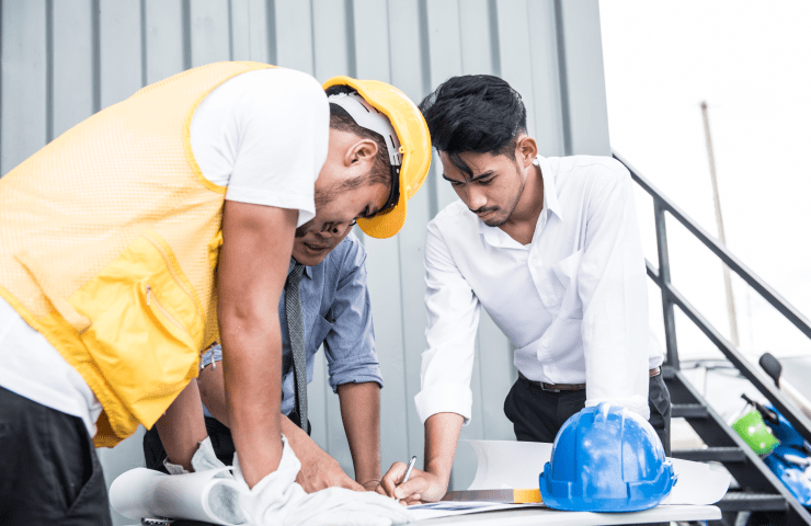 engineers and technicians reviewing ship design plans at shun shing ship building limited