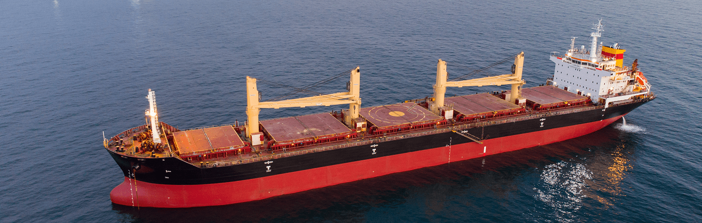 Large cargo ship sailing on open sea for freight transportation