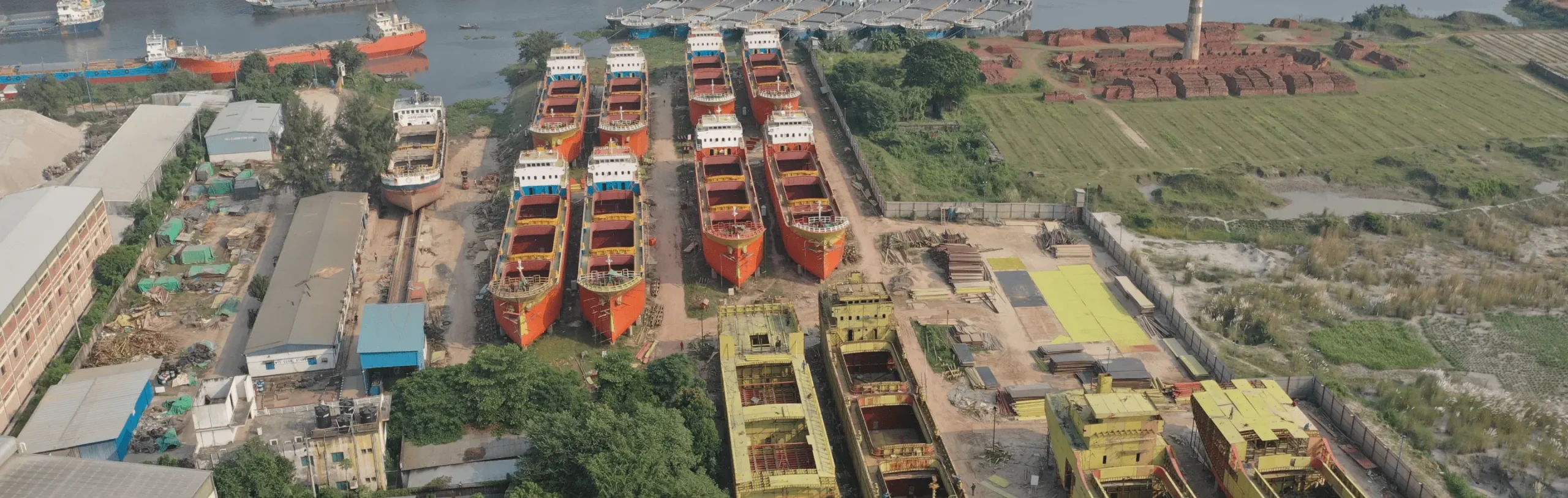 shun shing ship building limited shipyard with cargo vessels under construction aerial view