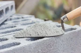 Close-up of high-quality cement being applied with a trowel from Seven Rings Cement.
